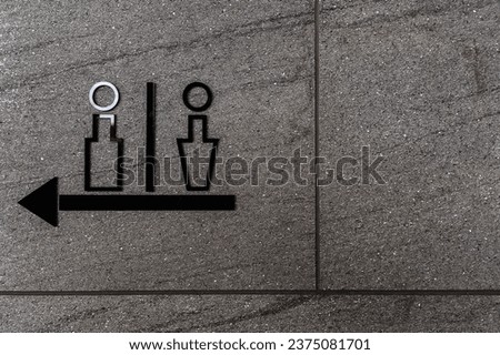 Men's and women's restroom signs in commercial buildings and directional arrows