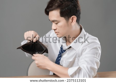Unhappy bankrupt man with empty wallet . man shows his empty wallet. Bankruptcy Royalty-Free Stock Photo #2375113101