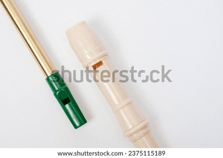 Irish whistle and block flute are longitudinal flutes with a whistle device and playing holes. Royalty-Free Stock Photo #2375115189