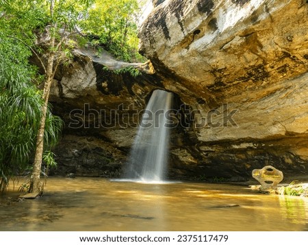 Saeng Chan waterfall in the deep humid forest at Ubon Ratchathani, Thailand, Leaf moving low-speed shutter blur.