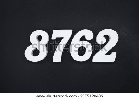 Black for the background. The number 8762 is made of white painted wood.