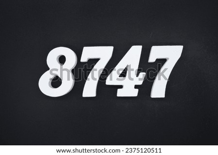 Black for the background. The number 8747 is made of white painted wood.