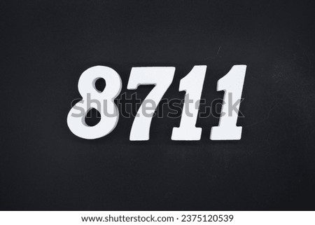 Black for the background. The number 8711 is made of white painted wood.