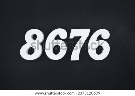 Black for the background. The number 8676 is made of white painted wood.