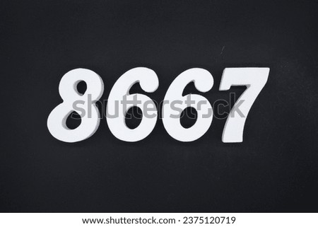 Black for the background. The number 8667 is made of white painted wood.
