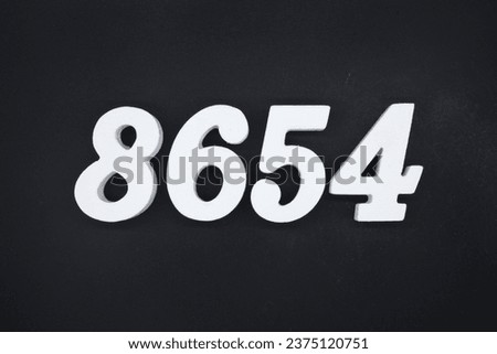 Black for the background. The number 8654 is made of white painted wood.