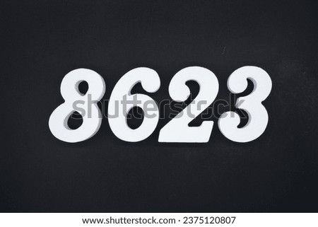 Black for the background. The number 8623 is made of white painted wood.