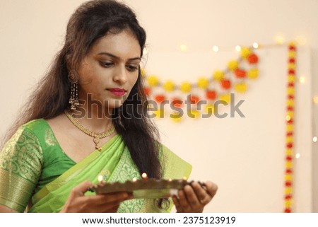 Beautiful Indian lady with green Saree at Diwali festival. 