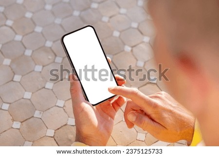 Mobile phone in hand, white screen mockup