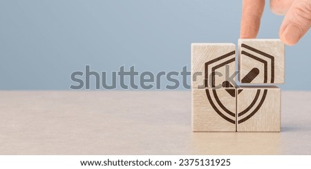 Insurance concept. Insurance and Assurance. Safety at work concept. Hand holds wooden cube with safety icons. safety first, protections, health, regulations and insurance