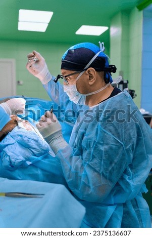 a surgeon performs an operation with a hospital