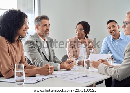 Diverse multicultural young and older business team people having discussion at office conference meeting. International professional executives board group working on corporate financial development. Royalty-Free Stock Photo #2375139525