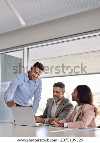 Happy business people executive team working at laptop using computer having discussion at office meeting showing financial project results consulting client investor at workplace, vertical. Royalty-Free Stock Photo #2375139529