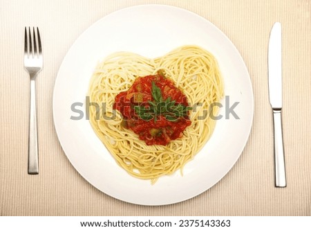 A picture of fresh spaghetti in the shape of a heart for Valentine's day
