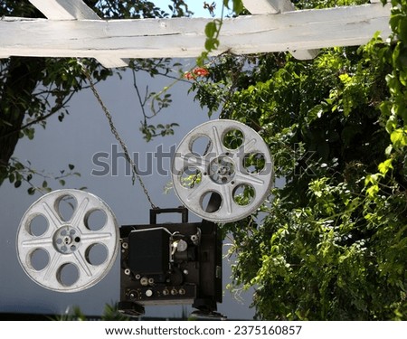An Image of Hanging Old Retro Film Projector Interior in Garden.