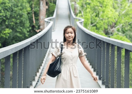 Asian woman travelling, close up of an asian woman feeling happy in the national park. Asian traveler.