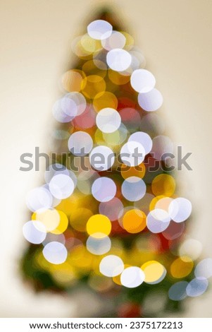 Vertical image of out of focus christmas tree with fairy lights with copy space background. Christmas, decorations, tradition and celebration concept.