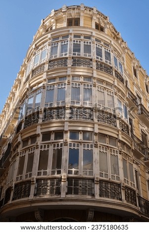 Old building with rounded corner, typical architecture of Malaga, southern Spain.