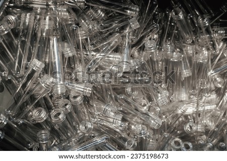 Up-close look at PET preform blanks assembled for the production of plastic bottles.