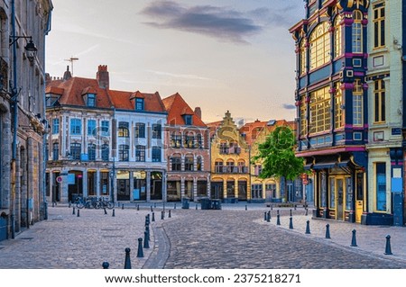 Vieux Lille old town quarter with empty narrow cobblestone street, paving stone square with old colorful buildings in historical city centre, French Flanders, Hauts-de-France Region, Northern France Royalty-Free Stock Photo #2375218271