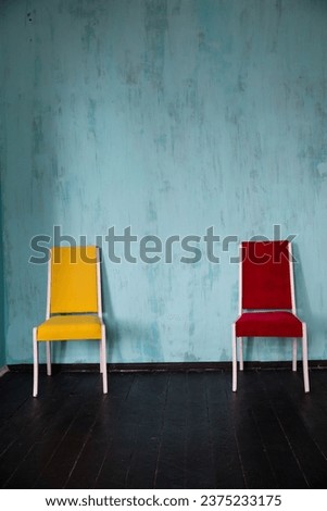 Yellow and red chair in the interior of an blue room