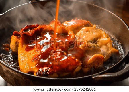 Put teriyaki sauce on grilled chicken Royalty-Free Stock Photo #2375242801