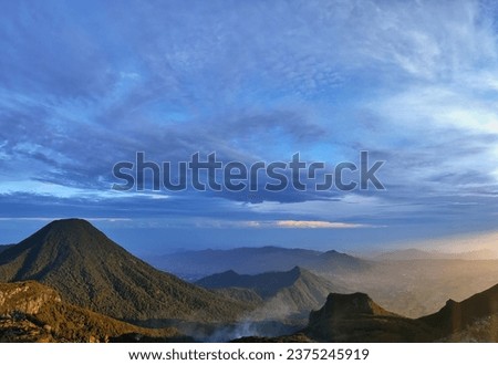 a picture of mountain range seen from the peak of Mount Gede Pangrango at sunrise - Bogor Indonesia 