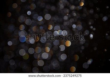 Luxury Bokeh with gold light and colurful rainbow curcle on black background
