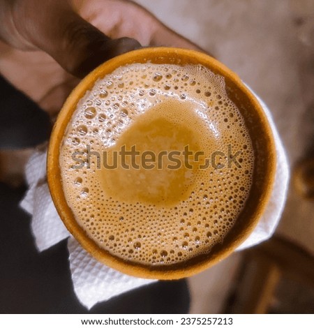 selective focus picture of a hand holding chai 