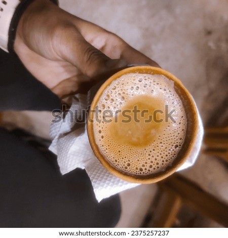 selective focus picture of a hand holding chai