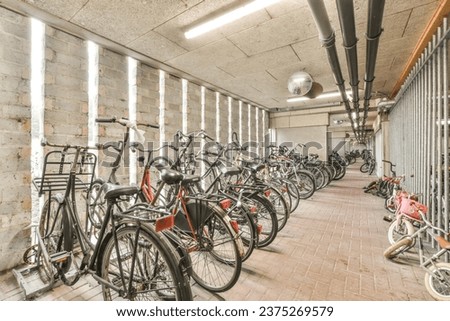 many bikes parked in a room with no one on the floor and two people standing next to each other bicycles Royalty-Free Stock Photo #2375269579
