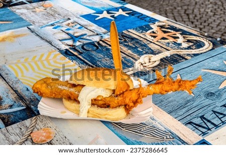 Bread roll with fried fish, Greetsiel, Germany Royalty-Free Stock Photo #2375286645