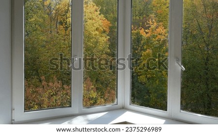 View from the window of the room on the park with yellow trees. Royalty-Free Stock Photo #2375296989