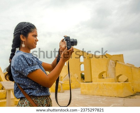 Woman tourist taking photos travel spots in Jaipur, India.