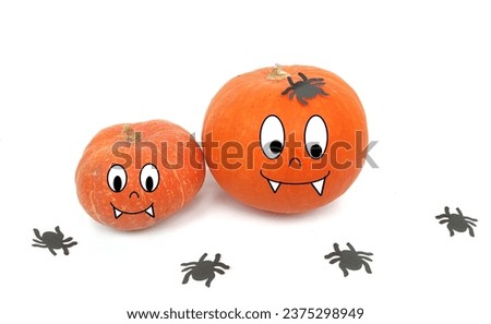 Halloween concept. Cartoon fresh pumpkin with funny facial expression with black paper spiders around on a white background. 