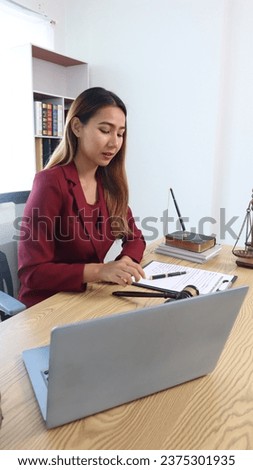 Portrait of a young female lawyer or lawyer working in an office. Smile and look at the camera.