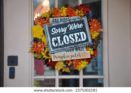 Sorry we're closed sign hanging in a door Royalty-Free Stock Photo #2375302181