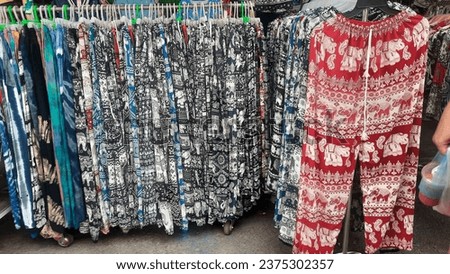 The colorful "elephant pants" hanging on the rail are lightweight, comfortable fabric pants.  The best fashion items from Thailand  It's a must buy for anyone who comes to Thailand.