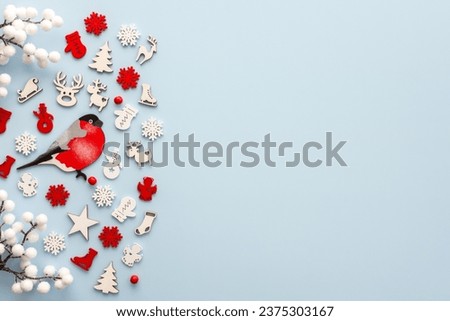 White and red Christmas toys on a blue background, Merry Christmas and Happy New Year concept, top view, copy space