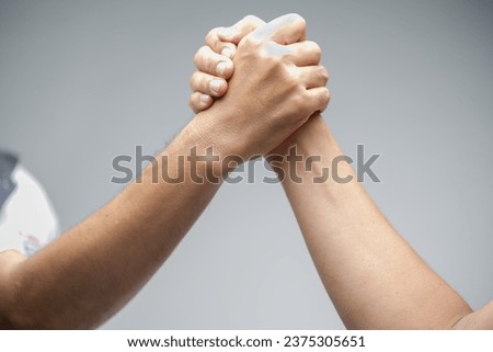 Two men arm wrestling on white background..Muscular hand.Men measuring forces of arms.Hand wrestling, compete.Hands or arms of man.Competition, strength and comparison concept.