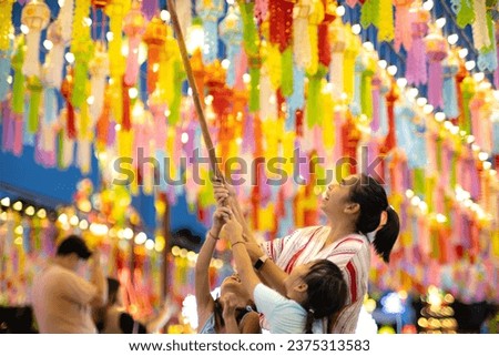 Asian families make wishes and hang lanterns during The Hundred Thousand Lantern Festival or Yi Peng Festival in northern Thailand. Royalty-Free Stock Photo #2375313583