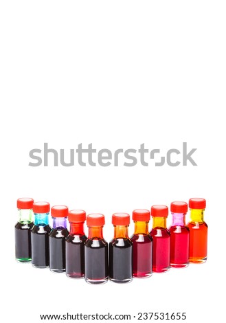 Different color variety of liquid food color additives over white background