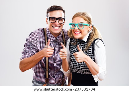 Happy nerdy couple showing thumbs up,Successful nerds Royalty-Free Stock Photo #237531784