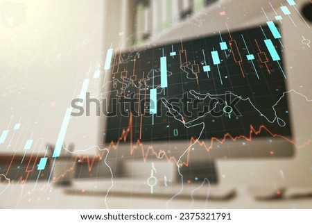 Double exposure of abstract creative financial chart with world map and modern desktop with laptop on background, research and strategy concept