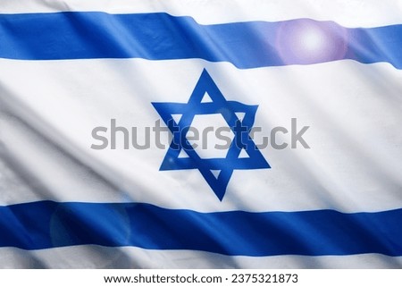 Israel flag. Independence Day of Israel. Israel flag beautifully waving wave with star of David over white wooden background. National pride of Israel. Patriotism and commonwealth. Top view. Mock up. Royalty-Free Stock Photo #2375321873