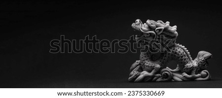 Gray dragon statue on a black background. The symbol of 2024. Happy Chinese New Year.