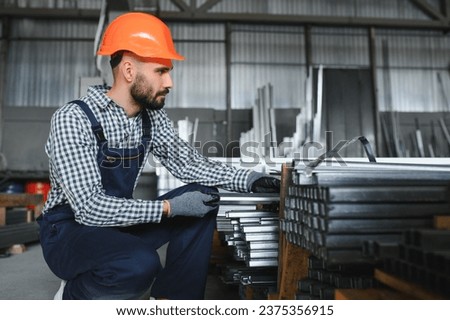 Factory worker measures the metal profile.