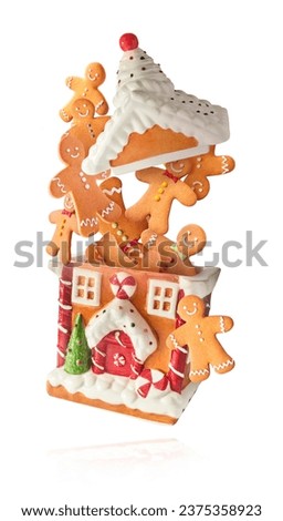 Christmas card. Falling in the air Christmas gingerbread cookies isolated on white background. Gingebread house and man cookies. Christmas levitation or zero gravity conception. High resolution image.