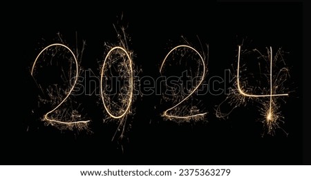 New Year 2024 text handmade written sparkles fireworks. Beautiful Shiny Golden numbers 2024 isolated on black background Royalty-Free Stock Photo #2375363279