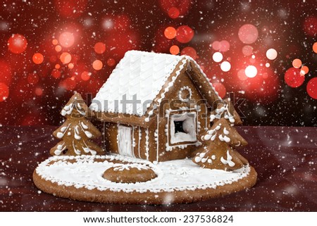 homenade holiday Gingerbread house with bokeh and snowflakes